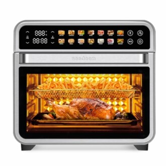 Digital air fryer oven cooking chicken and fries.