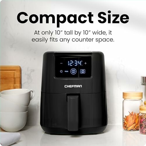 Compact Chefman air fryer on kitchen counter with cups and jars.