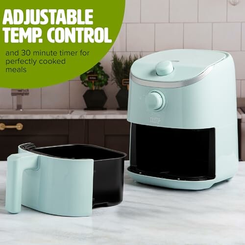 Compact air fryer with adjustable temperature control on kitchen counter.