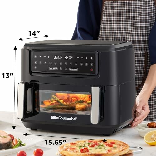 Elite Gourmet air fryer oven on kitchen counter with food.