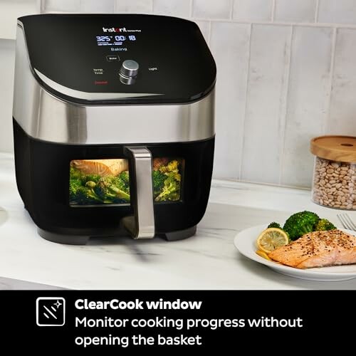Instant air fryer with ClearCook window cooking salmon and broccoli