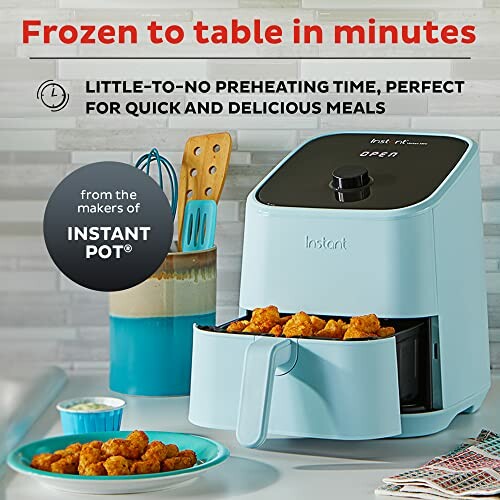 Instant air fryer with food, kitchen counter setting.