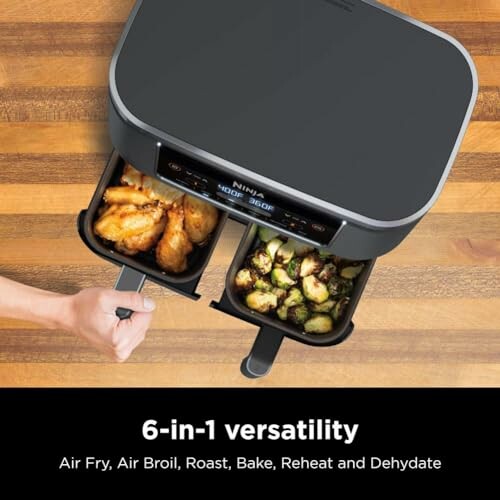 Ninja dual-basket air fryer with chicken and vegetables.