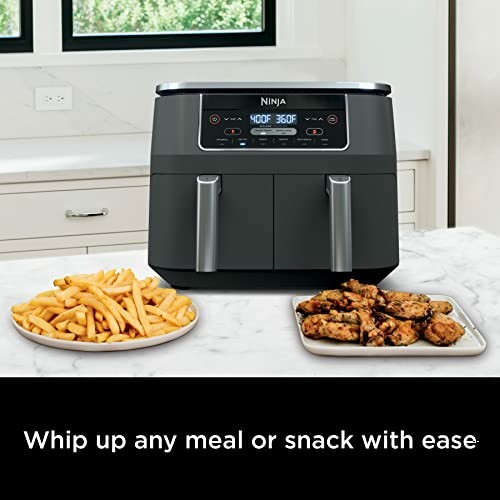 Ninja air fryer on counter with fries and chicken wings