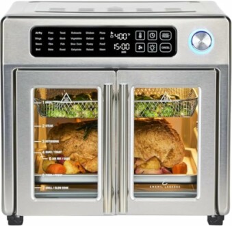 Stainless steel air fryer toaster oven with digital controls and food inside.