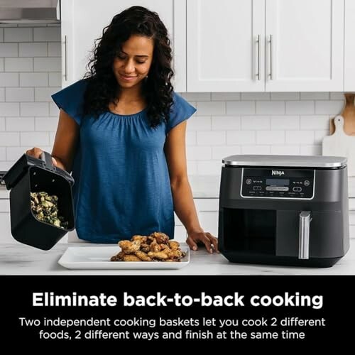 Woman using Ninja air fryer with two cooking baskets.